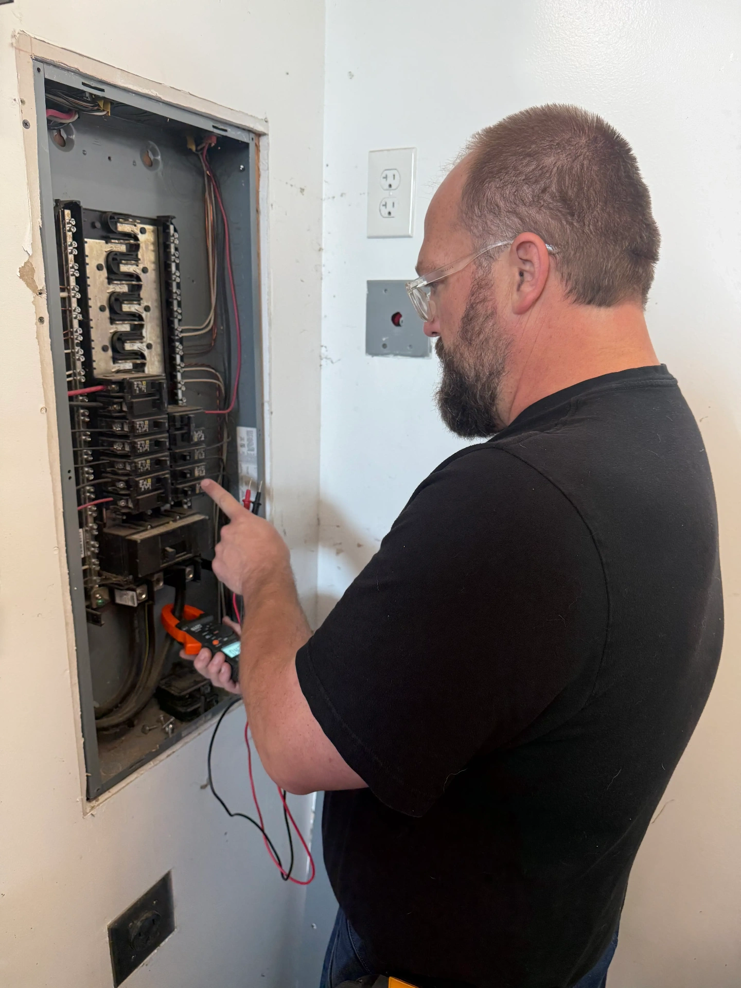 Tanner Smart using a multimeter to diagnose electrical issues — SmartEST troubleshooting services